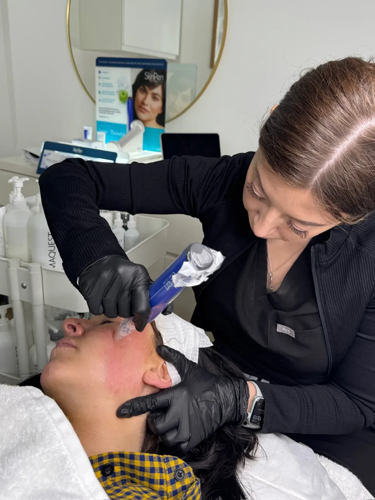 Emma carrying out SkinPen microneedling on a client
