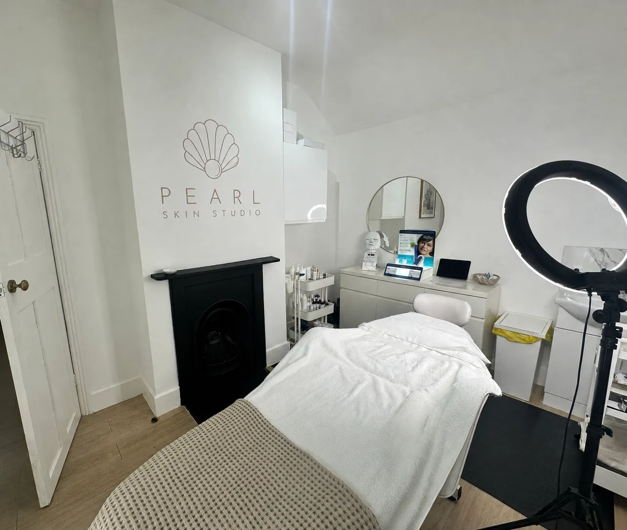 Pearl’s treatment bed and shell logo above the fireplace