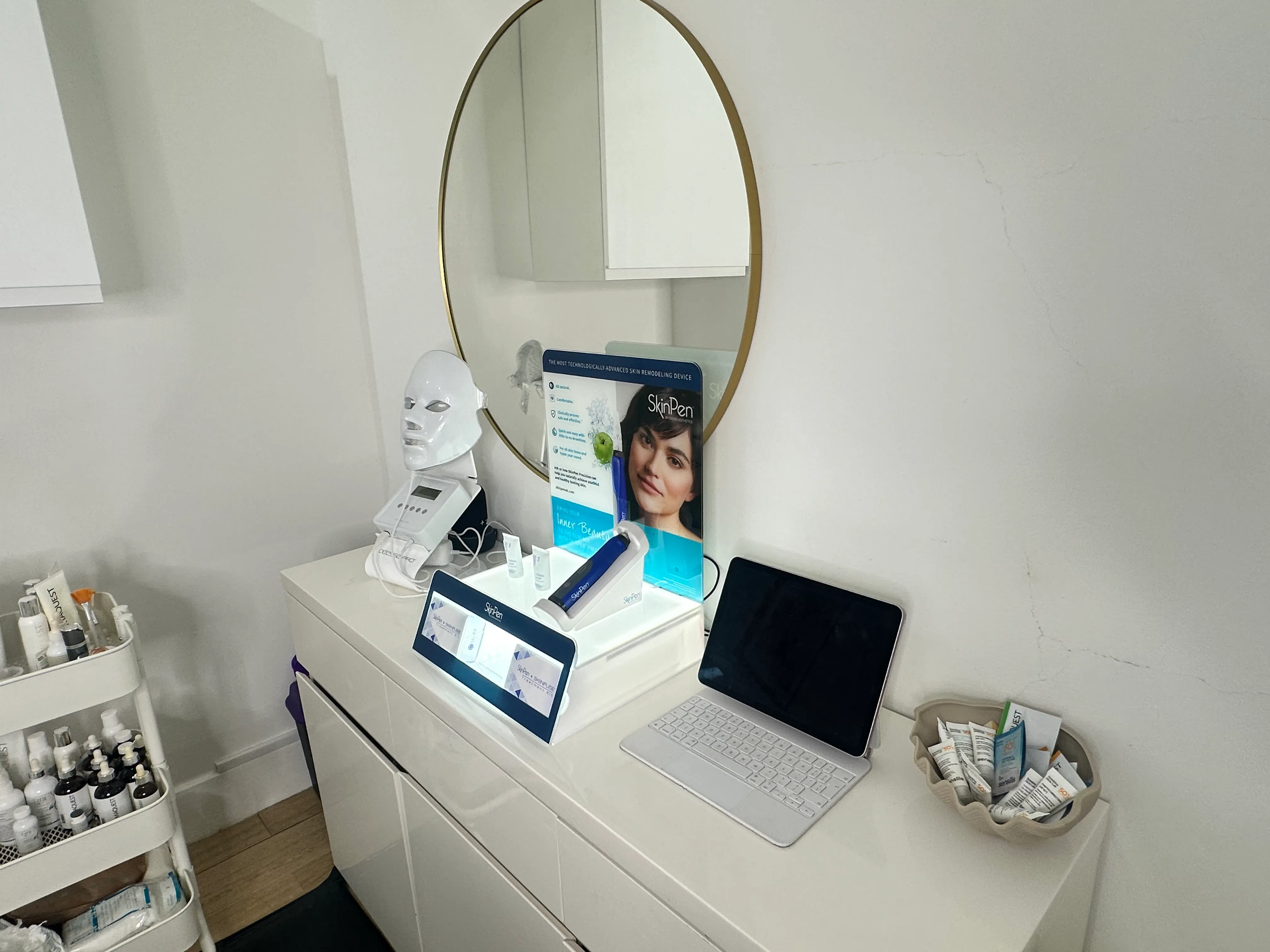 Professional skincare and equipment beside the studio mirror